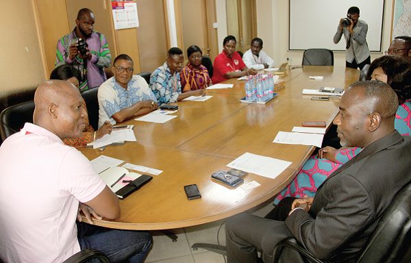 Mr Ato Afful (left), Managing Director, Graphic Communications Group Limited (GCGL) holding discussions with the GIJ delegation at his office in Accra. Picture: EDNA ADU-SERWAA