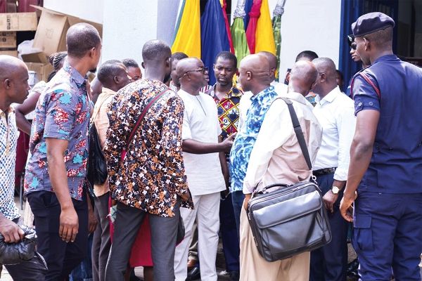 Mr Osei Assibey Antwi (arrowed) speaking to some shops owners in the Central Business District of Kumasi.