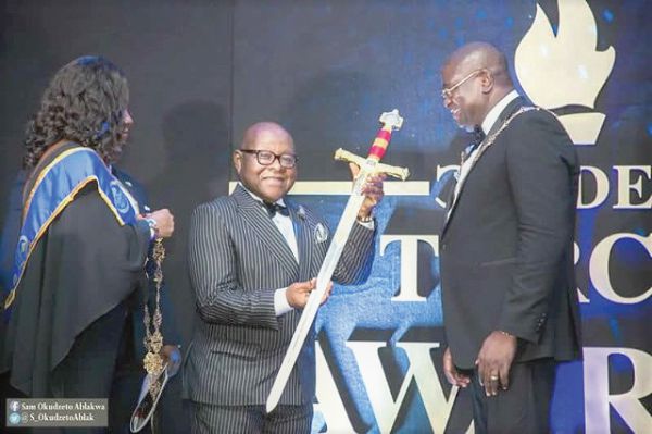  Prof.  Mike Oquaye (middle) after he had received the PRESEC Grand Companion Award