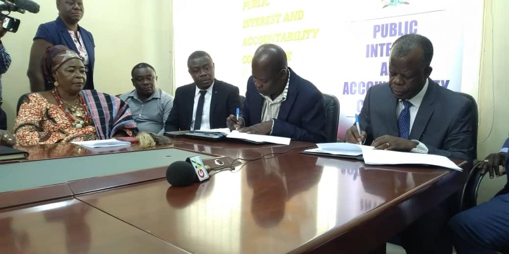 ACP K.K. Amoah (extreme right), Executive Director of EOCO and Dr Steve Manteaw, (2nd right) the Chairman of PIAC appending their signatures to the MoU for their respective organisations