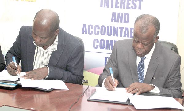 Dr Steve Manteaw (left), Chairman of the Public Interest and Accountability Committee (PIAC) and ACP Mr K. K. Amoah (retd) Executive Director of the Economic and Organised Crime Office (EOCO), signing the MoU in Accra.