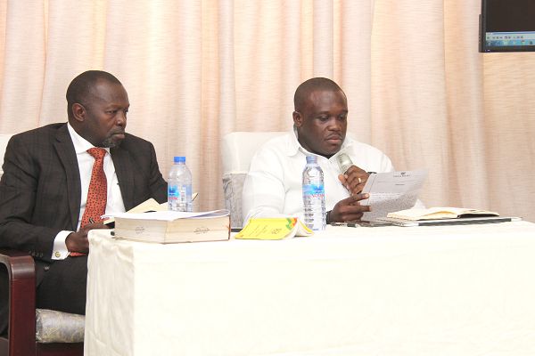 Mr Sam George, Member of Parliament, Ningo-Prampram given a document to check if that was his report. With him is Mr Dominic Ayine (left), MP, Bolga East as his counsellor. Picture: BENEDICT OBUOBI