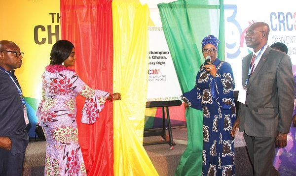 Mrs Cynthia Morrison (2nd right) being assisted by Dr Kojo Appiah-Kubi (right), Mr Micheal Gyato (left), Deputy Minister of Sanitation and Water Resources and Mrs Barbara Oteng-Gyasi (2nd left), Deputy Minister of Lands and Natural Resources to launch the anniversary. Picture: EDNA ADU-SERWAA