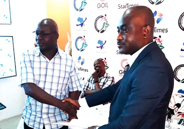 The Director of Television at StarTimes, George Lomotey (right) exchanging an MOU agreement with an official of Medivent Consult.