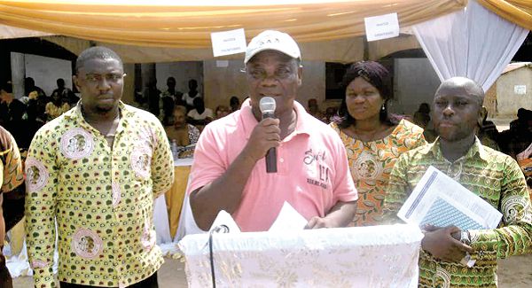 Mr Samuel Amponsah (inset) delivering a speech at the inauguration, while the farmers listen with rapt attention 