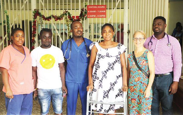 Dr Bulley (third left) flanked by Mr and Mrs Asimatey. With them are some members of the medical team