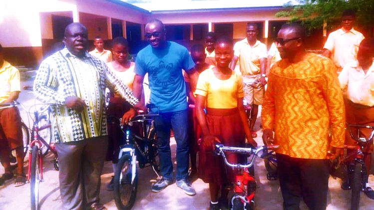  Mr Charles Agbeve(left), MP for Agortime-Ziope, handing over the bicycles to beneficiaries