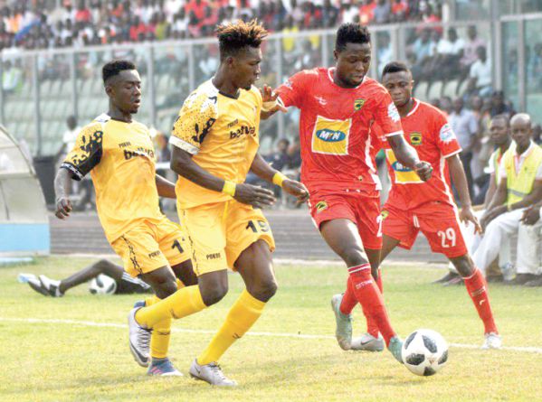 Ashgold’s Habib Mohammed (No.19) closes in on Kotoko’s Agyemang Badu to stop him from advancing with the ball Pictures: EMMANUEL BAAH