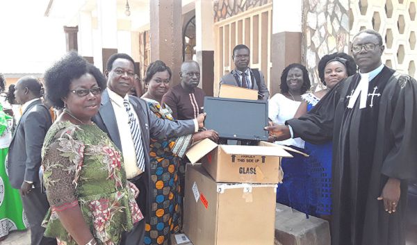 Mr Hanson Obeng Asamoah (2nd left) presenting the items to Rev. Christian Amankwa Kwafo (1st right). With them are some members of the association and the church.