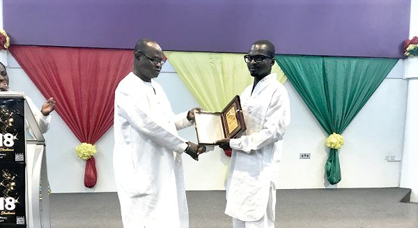 Mr Felix Abayateye (left) receiving his award from Franklin Boateng