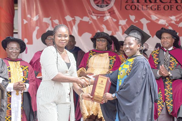 Ms Yvonne Aryee (left),Corporate Communications Officer  of Graphic Communications Group Ltd presenting the Graphic award for the over-all best student in Journalism to Ms Jessica Johnson(right), during the 15th graduation ceremony. Picture: ESTHER ADJEI 