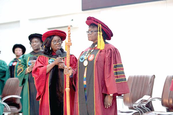Dr Mrs Abigail Agartha Kyei (right) taking the induction oath