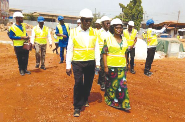 Ms Gifty Ohene-Konadu (right), leading the group chairman of Kasapreko, Dr Kwabena Adjei and others to tour the 10,000 metre square layout