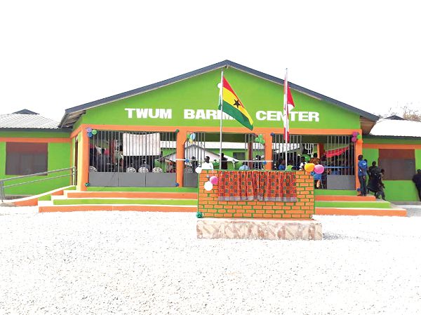 The front view of the building. INSET:Nana Akosua Fima Dwaben (middle) being assisted by Most Rev. Prof. Asante to cut the tape to inaugurate the centre.