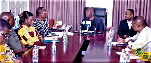 Mr Kojo Oppong Nkrumah (middle) interacting with the executive of the Ghana Journalists Association at his office in Accra