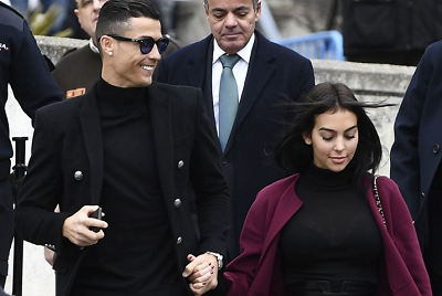Juventus' forward and former Real Madrid player Cristiano Ronaldo leaves with his Spanish girlfriend Georgina Rodriguez after attending a court hearing for tax evasion in Madrid on January 22, 2019. - Ronaldo is expected to be given a hefty fine after Spanish tax authorities and the player's advisors made a deal to settle claims he hid income generated from image rights when he played for Real Madrid. (Photo: AFP)