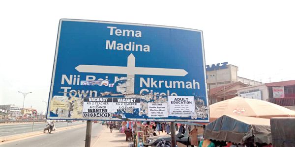  A directional signpost at Lapaz that has been turned into an advertising board