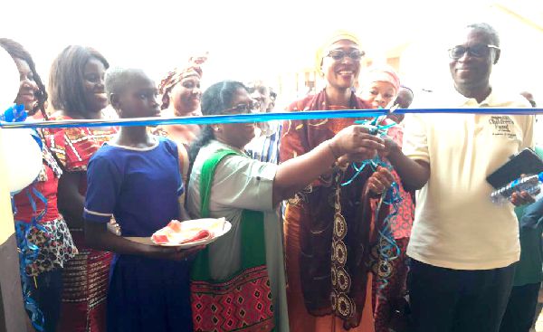  Madam Mariam Iddrisu (middle), the MCE for Sagnarigu being assisted by Dr Belinda Bennet, Chief International Programme Officer of CCFC and Mr Baiden, the Country Director of CCFC to cut the tape to inaugurate the facility