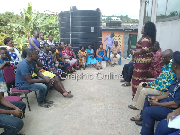 The poilce CID boss Madam Tiwaa Addo-Danquah (standing), speaking with the family of one of the kidnapped girls
