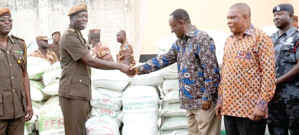 FLASHBACK: Dr Owusu Afriyie Akoto (right) handing over some bags of fertiliser to Mr Patrick Darko Missah, Director-General of the Ghana Prisons Service when the ministry launched the 2018 PFJ at the Nsawam Prisons