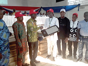 Mr Daniel Okyem Aboagye (4th right) presenting a streetlight to Mr Thomas Clarence Ababio (3rd left). Looking on are some constituency executive members.