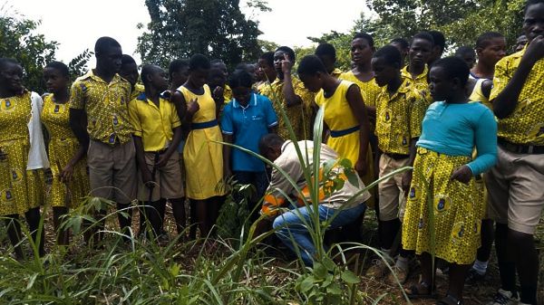 Mr Sylvester Awozum, the Mpraeso Area Head of EPA interacting with students during the tree planting exercise