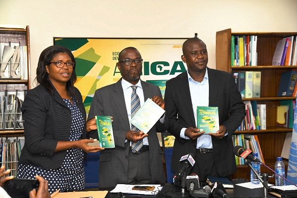Mr Phillip Cobbina (middle), consultant , Circadian Consulting Limited, flanked by Ms Cynthia Prah, National Information Officer of the UNIC, and Mr Albert Yelifari (right), Ministry of Trade and Industry, launching the Economic Development in Africa Report in Accra yesterday. Picture: EBOW HANSON