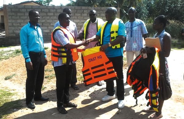 Mr Thomas Musa, handing over the life jackets to Mr Ato Kwamina Dompoh, who received them on behalf of the teachers. Picture: Benjamin Xornam Glover