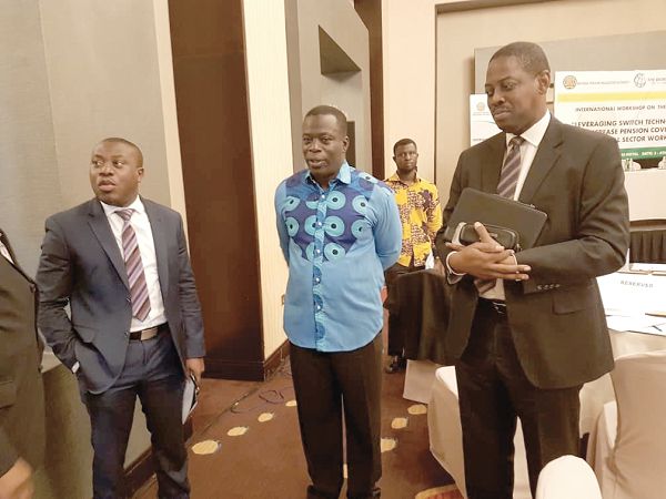 Mr Ignatius Baffour Awuah (middle) interacting with some dignitaries after addressing the workshop 