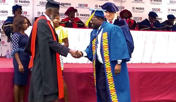 Prof. Stephen Adei (left) presenting a certificate to one of the graduands. Picture: Nii Martey Botchwey