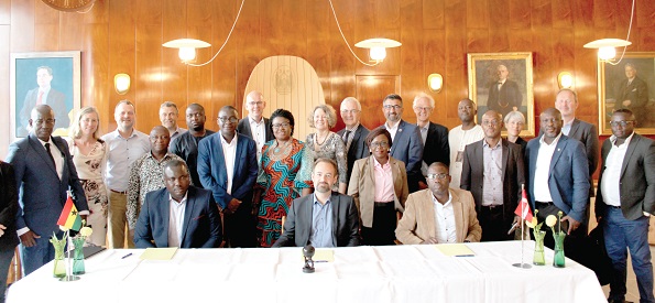 Mr Felix Mensah Nii Anang-La (seated left) and Mr Jacob Bundsgaard (seated middle) with officials from Ghana and Denmark. With them is Mrs Tove Dengbol (arrowed), Danish Ambassador to Ghana
