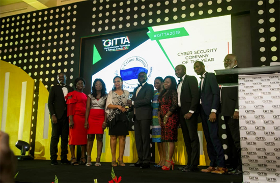 Mr Abraham Kofi Asante (5th left) CEO of the Ghana Investment Fund for Electronic Communications (GIFEC) presenting the award to Dr Suzanne Nti, a Senior Consultant of e-Crime Bureau. Looking on is the e-Crime Bureau team.