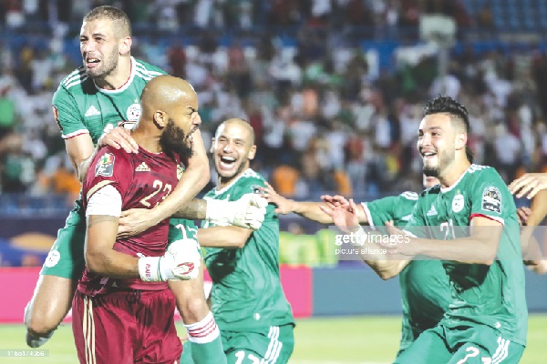  Algeria players celebrate with goalkeeper  Rais M'Bolhi after their shootout victory