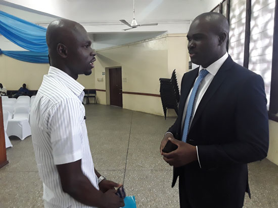 Mr Peter Larbi-Yeboa (right) interacting with a unit holder at the AGM.