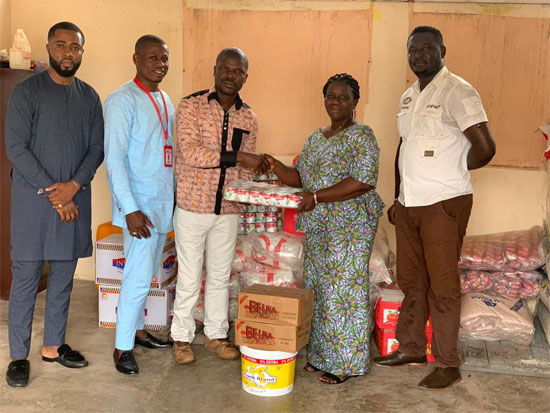 Mrs. Mensah-Akutteh receiving the cheque from Mr. Arthur