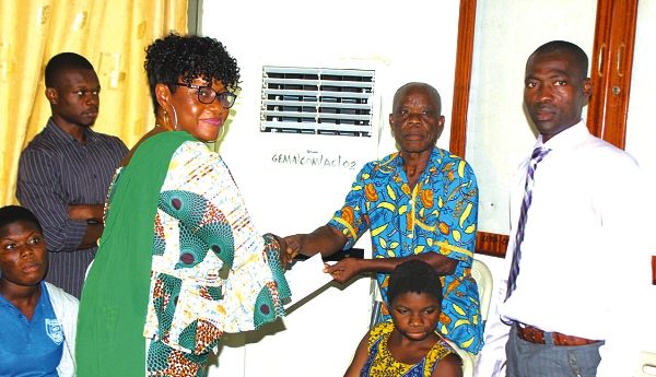 Ms Janet Tulasi Mensah (left) presenting a cheque to Mr Nelson Agbesi (2nd right), a beneficiary. Looking on is Mr Bismark Gyamfi (right), President Ghana Federation of Disability Organisation (GFD). Picture: Maxwell Ocloo