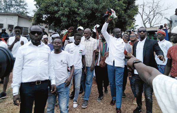 Mr Mubarick Masawudu (2nd right) responds to cheers from his supporters at the regional party headquarters in Kumasi