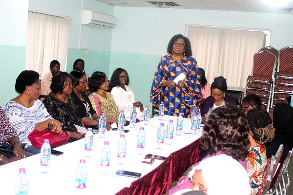 Mrs Mavis Kitcher (standing) making a contribution at a roundtable discussion in Accra. Seated on her left is Mrs Ifeyinnwa Omowole.  Picture: GABRIEL AHIABOR 