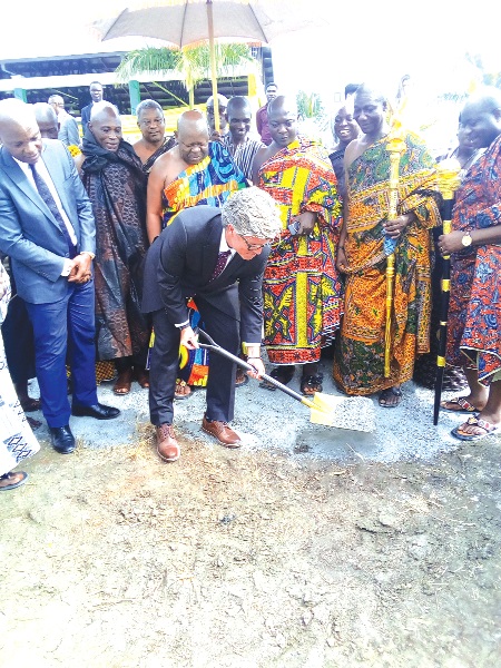  Prof. Stephen Alder cutting the sword for the building. Looking on are members of the board and Nene Sakite II (3rd left), and Togbe Afede XIV (left)