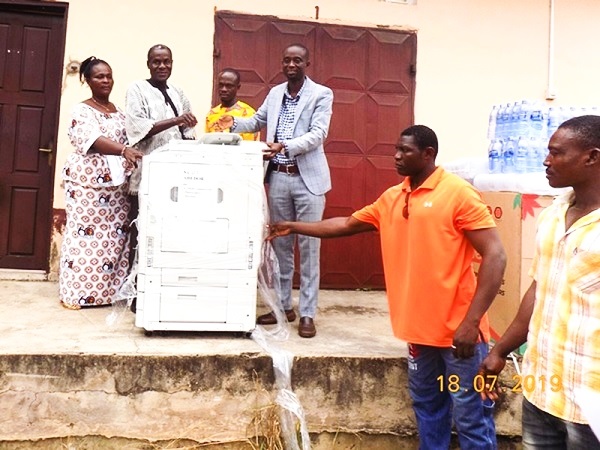 Mr Isaac Kodjo Buabeng (3rd right) presenting a  multi-purpose commercial photo copier to S.C.D.K. Ahedor (2nd left)