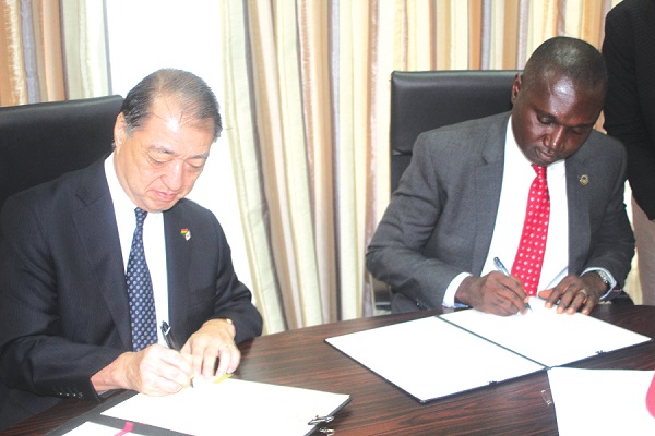 Mr Charles Owiredu (right), Deputy Minister of Foreign Affairs and Regional Integration and Mr Tsutomu Himeno, Japanese  Ambassador to Ghana, jointly signing the agreement 