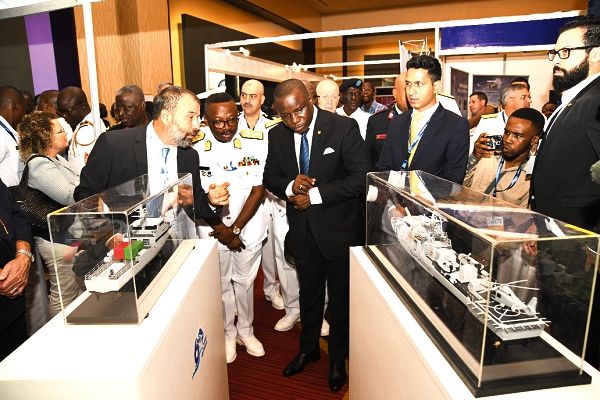  Mr Dominic Nitiwul, the Minister of Defence, inspecting a miniature ship at the stand of Israel Shipyard Limited during an exhibition which was mounted as part of the International Maritime Defence Exhibition and Conference. With him are Oded Breier (left), the Vice-President of Israel Shipyard Limited, and Real Admiral Seth Amoama (2nd left), Chief of the Naval Staff. Picture: EBOW HANSON