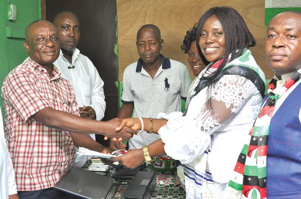 Ms Rita Odoley Sowah (right) presenting her nomination forms to Mr Abraham Oko Kotey (left), Director of Elections, La Dadekotopon NDC. Picture: NII MARTEY M. BOTCHWAY