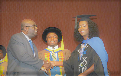 Mr Francis Kojo Dadzie (left), the Executive Director of the Advertising Association of Ghana, presenting an award to Nana Ama Buadiba Osei (right), the Overall Best Graduating Student, UPSA at the 11th Congregation. Picture: ESTHER ADJEI