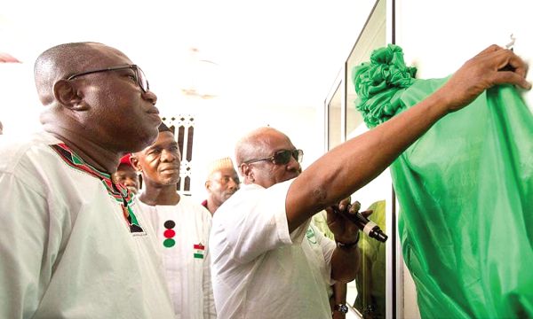 Former President John Mahama unveiling the plaque of the new NDC office complex in the Bono East Region