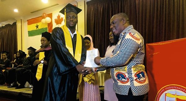 Mr Samuel Ntow (right) presenting a certificate to Master D.D Lawer, one of the graduands.