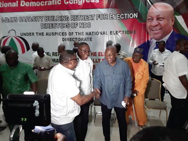 Mr Elvis Afriyie Ankrah (left), NDC Director of Elections, interacting with former President John Mahama after opening the training programme. With them is Mr Samuel Ofosu Ampofo (2nd left), NDC National Chairman