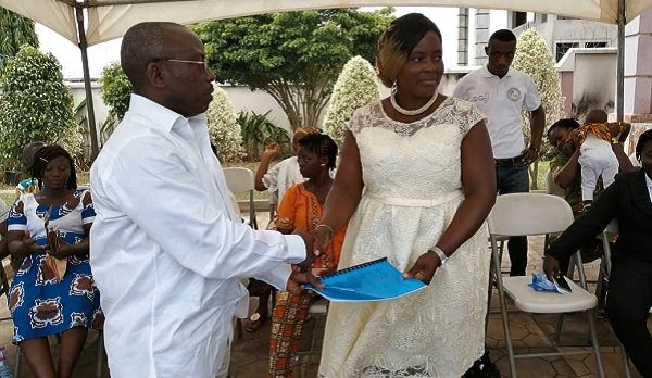  Mr Robert Austin (left) presenting the MoU to the leader of the nursery operators, Ms Joyce Mensah