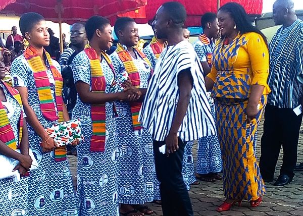Mr Dennis Edward Aboagye, Akuapem North Municipal Chief Executive, leading Nana Ama Dokua Asiamah-Adjei, MP for Akuapem North and Mr Dan Botwe, Minister of Regional Re-organisation and Development to congratulate the award winners