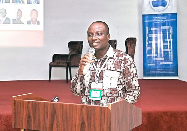 Mr George Kojo Addison (inset) speaking at the conference. MAIN PICTURE: Some participants in the conference 